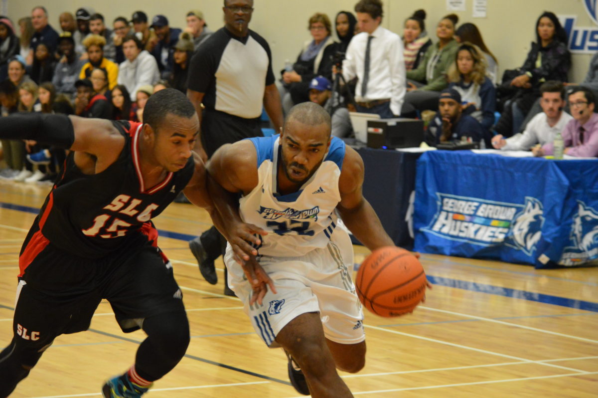 George Brown Huskies guard Ajahmo Clarke dribbles to the net.
