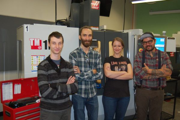 Matthew Arch (left), Enrique Burdman, Anne Croll and Matt Vincent with one of Casa Loma campus’ CNC