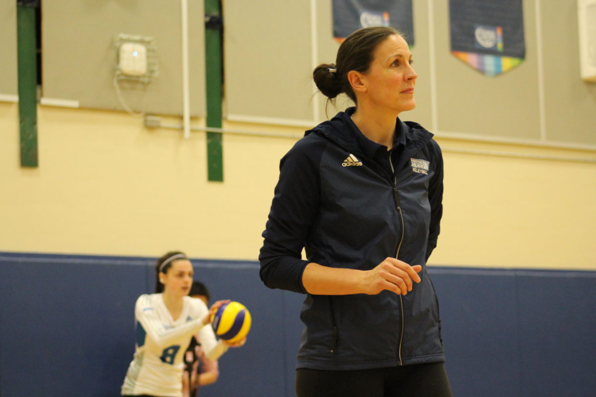 Huskies head coach Dana Cooke with athlete Julia Vit in background