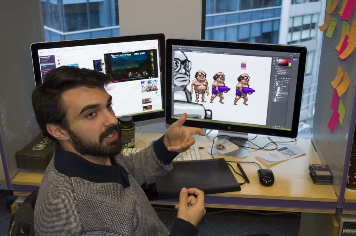 Alex Rushdy shows off his new game Lube Slidewalker at the Global Game Jam on Jan. 20. Photo: Drake Snider