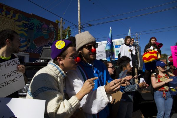 Students look at their chant sheet during a performance in support of striking faculty at Humber College’s Lakeshore Campus on Friday, October 20, 2017. Students wrote the chant and organized the performance themselves. Photo: Kit Kolbegger / The Spare