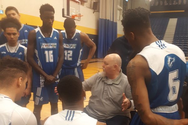 GBC head coach Jonathan Smith talks with the team during a break at the East / West Holiday Series. Photo: Matthew Green / The Dialog