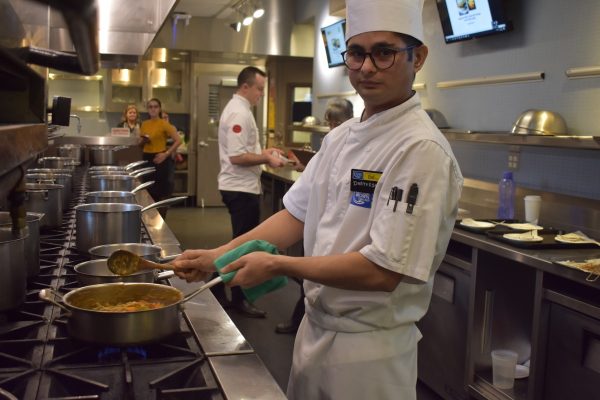 Dhayvesh Sidhpura preparing his dish. Photo: Ladshia Jeyakanthan / The Dialog