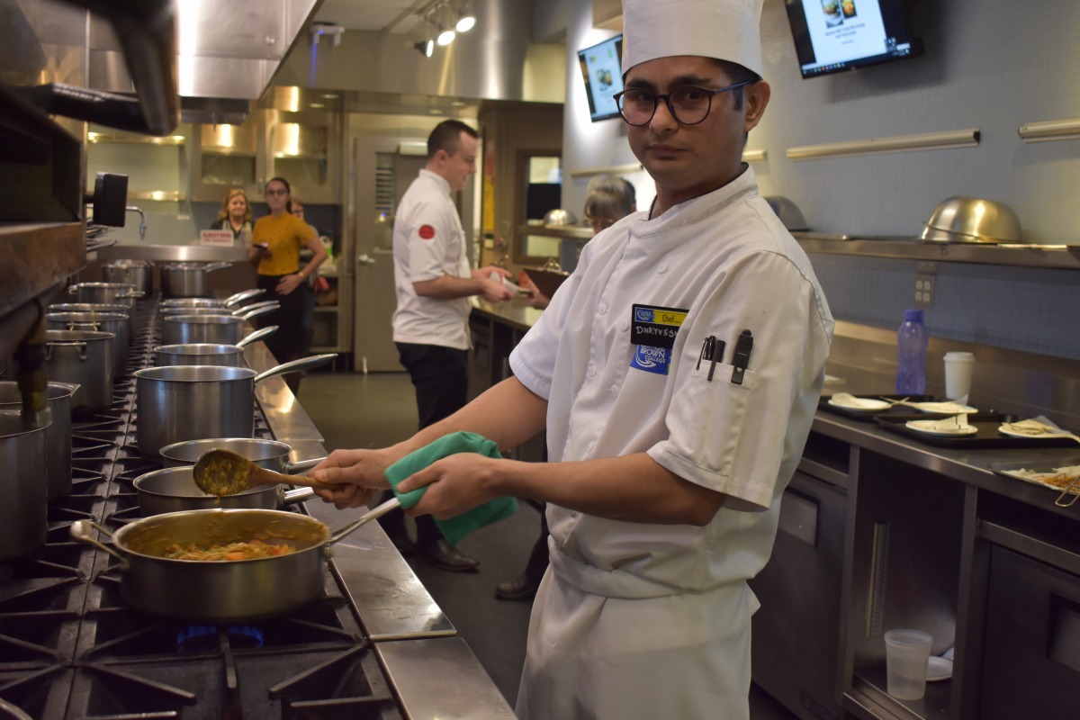 Dhayvesh Sidhpura preparing his dish. Photo: Ladshia Jeyakanthan / The Dialog