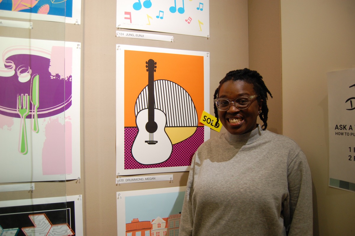 Megan Drummond, with her sold Cajun restaurant themed poster. Photo: Timo Cheah / The Dialog.