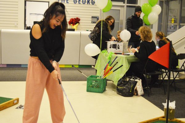 Evelin Cheung, left, celebrates her win at Turn Down for Putt. Photo: Nico deVeber / The Dialog