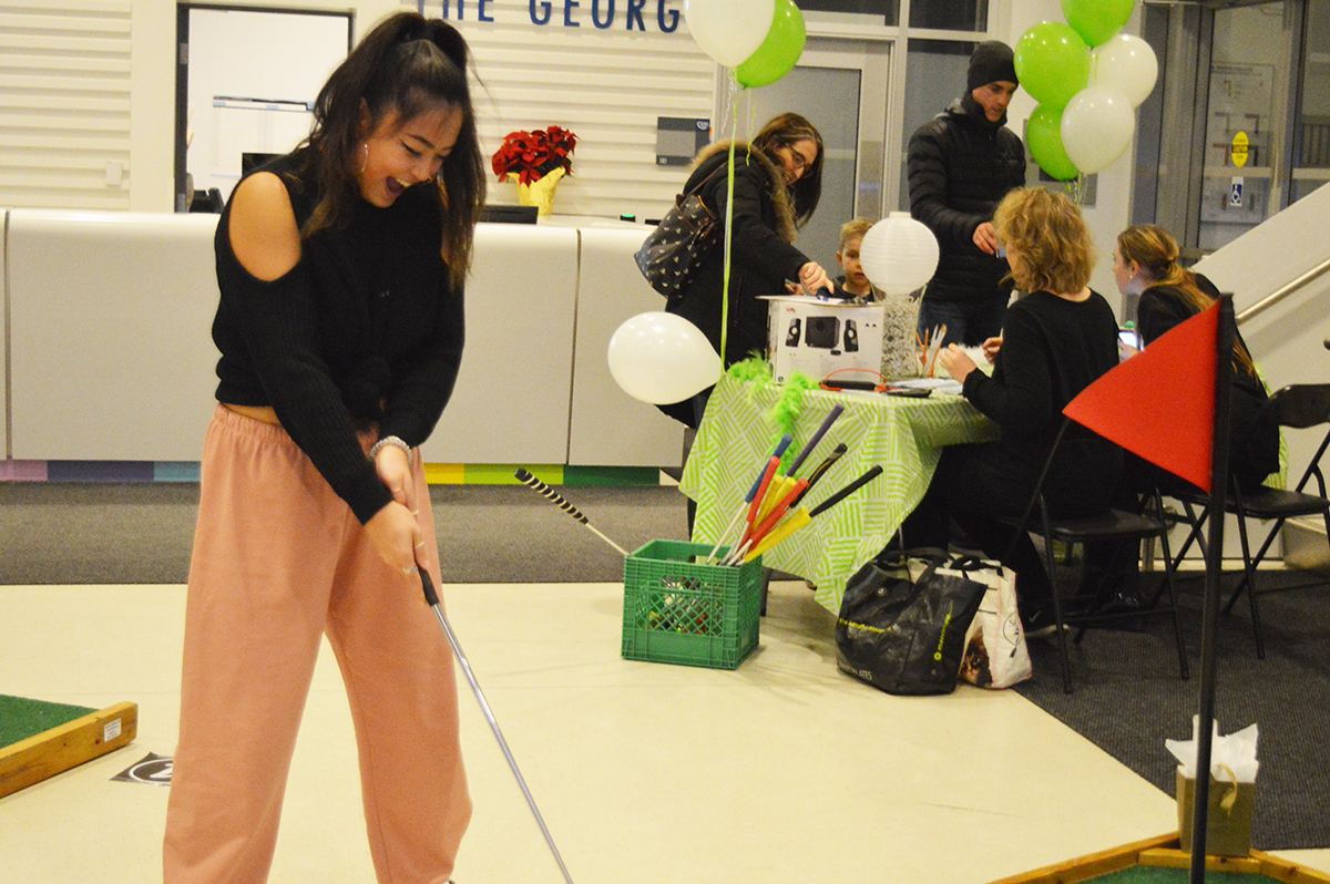 Evelin Cheung, left, celebrates her win at Turn Down for Putt. Photo: Nico deVeber / The Dialog